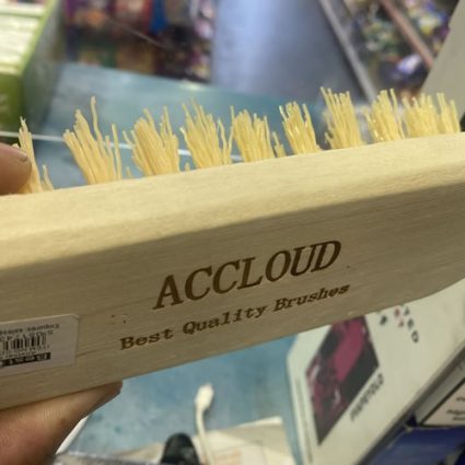 Close-up of a wooden brush with natural bristles labeled ACCLOUD Best Quality Brushes on the handle