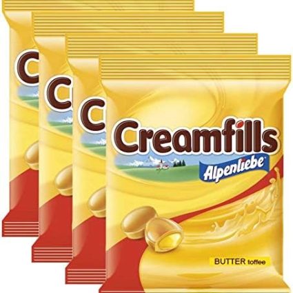 Four bags of Alpenliebe Creamfills butter‑toffee candy arranged in a staggered row, showing yellow packaging and logo.