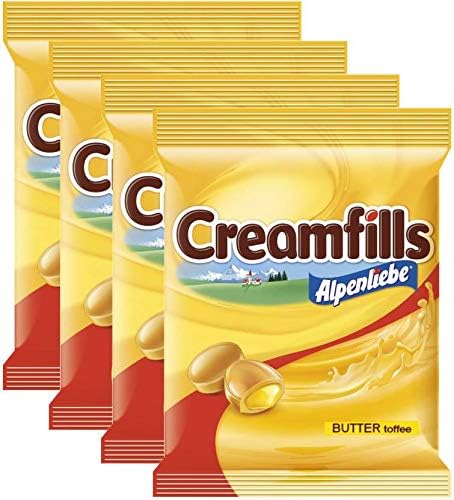 Alpenliebe Creamfills Butter Toffee Centre Filled Candy1 - Imavug Four bags of Alpenliebe Creamfills butter‑toffee candy arranged in a staggered row, showing yellow packaging and logo.