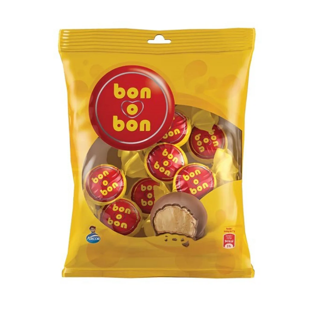 BON O BON MILK - Imavug Bag of Bon o Bon chocolates in a yellow package with a red circular logo; one piece bitten to show creamy filling inside