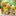 Assorted Chi Exotic Pineapple & Coconut Nectar drink cartons in different sizes on a table outdoors, featuring bright yellow packaging with pineapples and coconuts.