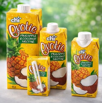 Assorted Chi Exotic Pineapple & Coconut Nectar drink cartons in different sizes on a table outdoors, featuring bright yellow packaging with pineapples and coconuts.