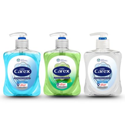 Three Carex hand wash bottles with pumps—blue, green, and clear, lined up.
