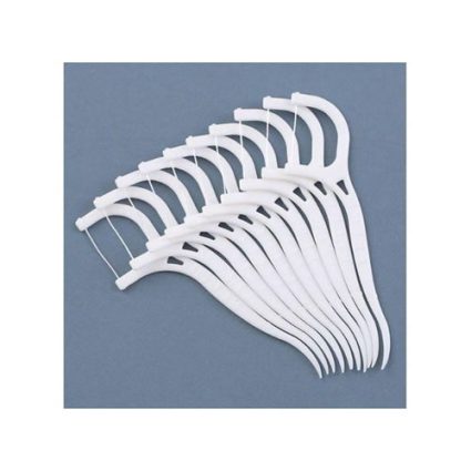 White plastic clothes hangers fanned in a curved stack against a gray-blue background.