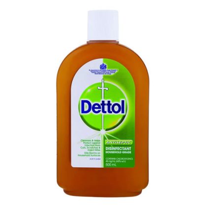 Bottle of Dettol antiseptic disinfectant (500 mL) with orange-brown liquid and white cap, labeled Dettol green-and-white bottle art.
