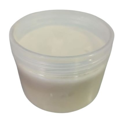 Off-white cream in a translucent jar, opened and ready to use