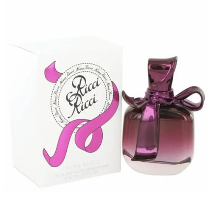 Purple gradient perfume bottle with a pink ribbon bow beside its white Ricci Ricci packaging.