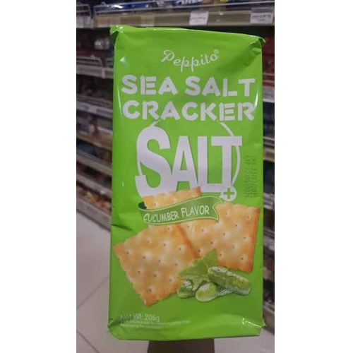 Peppito Sea Salt Cracker Salt Cucumber Flavour - Imavug Bright green Pepito Sea Salt Cracker bag with cucumber flavor, on a store shelf in front of crackers.
