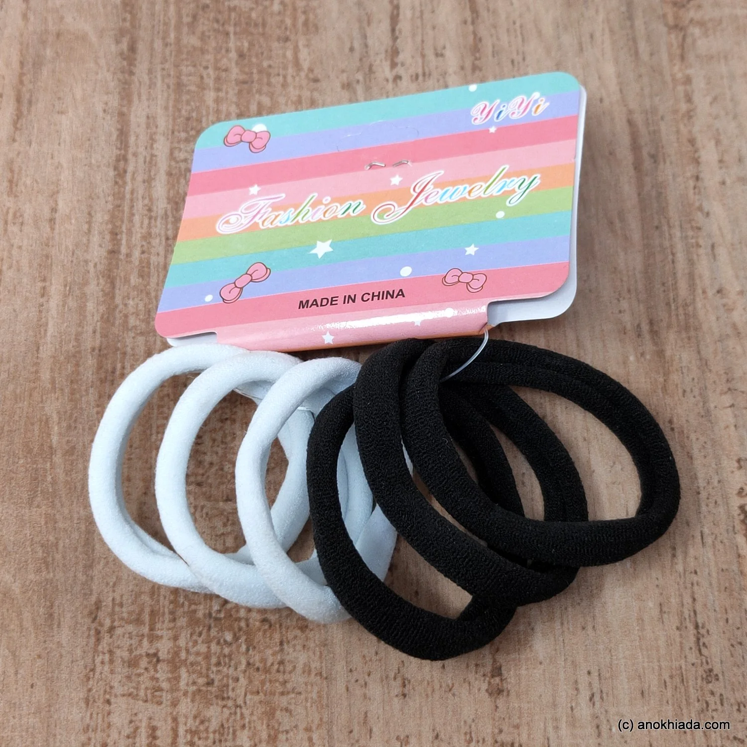 Ponytail Rubber Bands - Imavug Rainbow-striped card labeled Fashion Jewelry with white and black hair elastics.