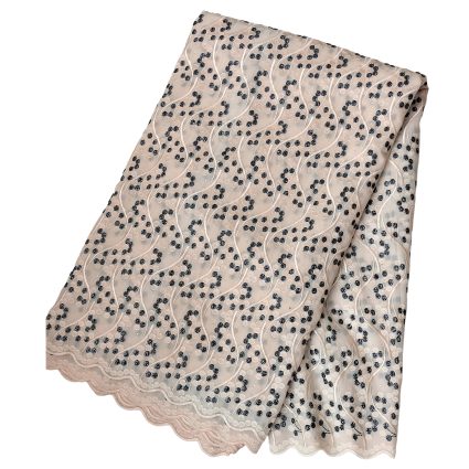 Beige lace fabric with black dotted clusters and wavy embroidery along a scalloped edge