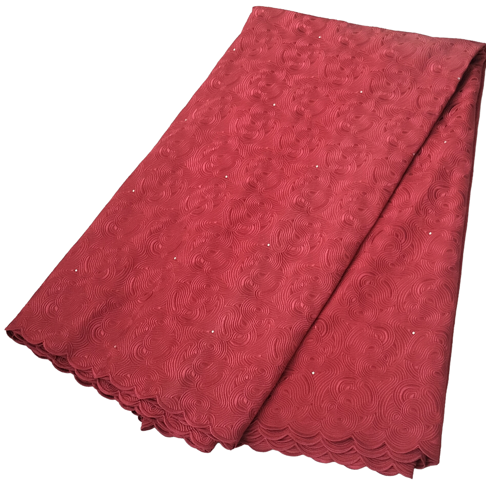 Premium Brick Red Swiss Voile Fabric with Tone-on-Tone All-Over Swirl Embroidery 5 Yards - Imavug Red lace fabric with circular embossed pattern and scalloped edge, folded neatly.