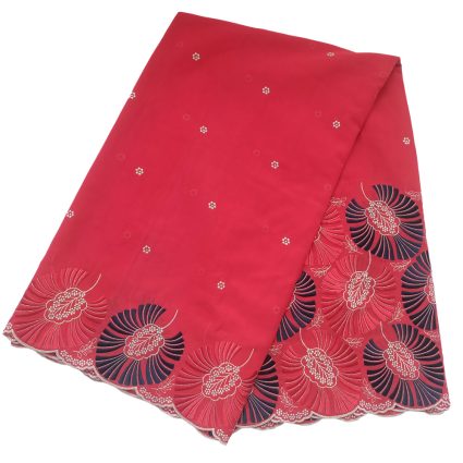 Pink fabric with a scalloped hem and navy-white circular floral embroidery along the edge, decorative textile piece.