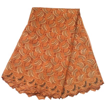 Orange lace fabric with a scalloped hem forming a layered skirt-like piece, featuring swirling paisley-like pattern and small cutouts/embroidery accents.