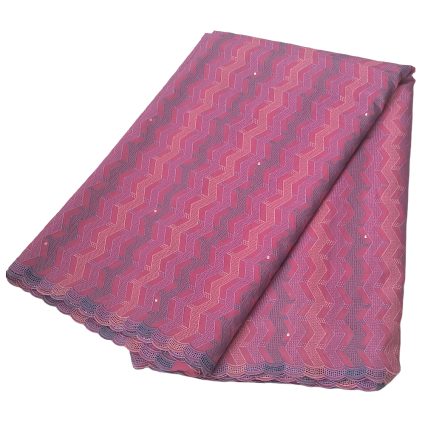 Pink fabric folded to show its pink chevron/zigzag pattern and scalloped lace border