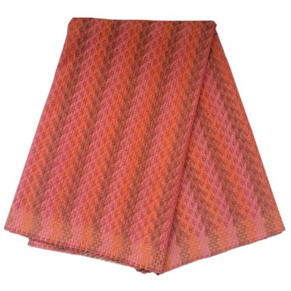 Pink and orange patterned skirt with a repeating lace-like geometric motif.