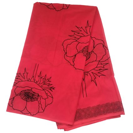 Bright pink scarf-like fabric with large black floral outline motifs and a decorative border along the edge.