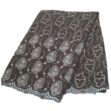 Dark gray lace fabric with repeating white heart-shaped and floral embroidery along a scalloped edge.