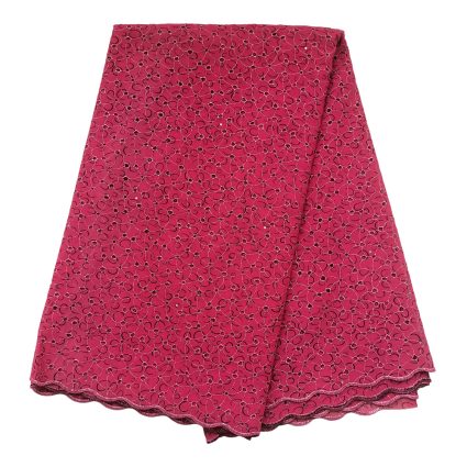 Pink lace fabric with a repeating circular floral pattern and scalloped edge, folded in layered sheets.