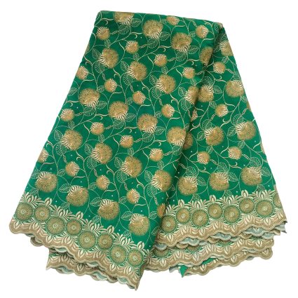 Green fabric with gold embroidered floral pattern and a scalloped beige border