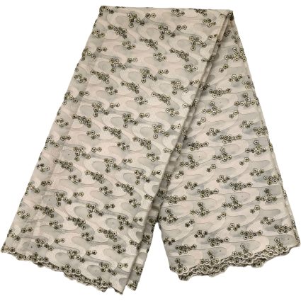 Folded beige fabric with a repeating pink wavy pattern and small clustered flowers along the edges, scalloped trim visible.