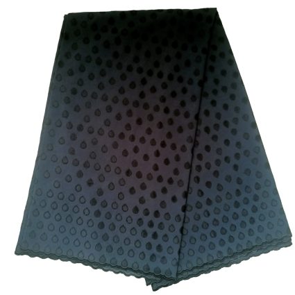 Folded teal fabric with a dotted pattern and scalloped edge