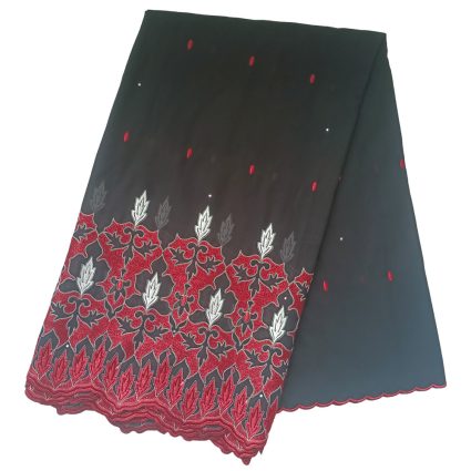 Dark fabric sample with red and silver floral embroidery along the lower border and a scalloped red trim.