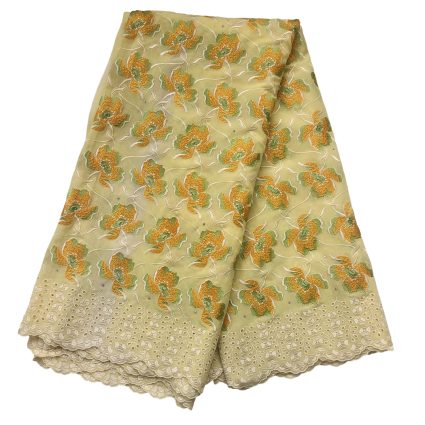 Beige fabric with orange and green embroidered flowers and a scalloped lace hem at the bottom edge, on a pale background.