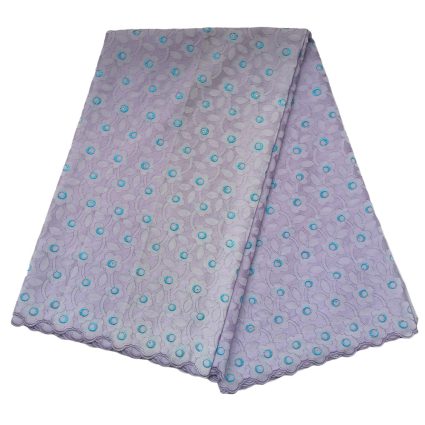 Folded lavender lace fabric with turquoise circular embroidery and scalloped edges.