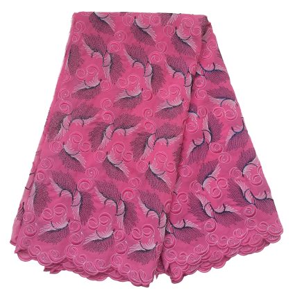 Pink fabric with dark feather-like embroidery and pink swirl motifs along a scalloped edge, likely a decorative garment