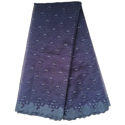 Purple-blue lace fabric with a scalloped floral border, folded to show a decorative pattern of waves and small motifs on the edges.