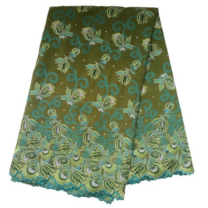 Olive green fabric with turquoise scroll patterns and green/cream floral embroidery along the hem.
