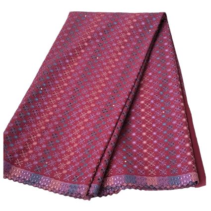 Pink fabric with tiny purple floral pattern and scalloped lace border, folded diagonally.