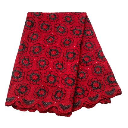 Red lace fabric with bold black-outlined flower motifs and scalloped edge, folded for display