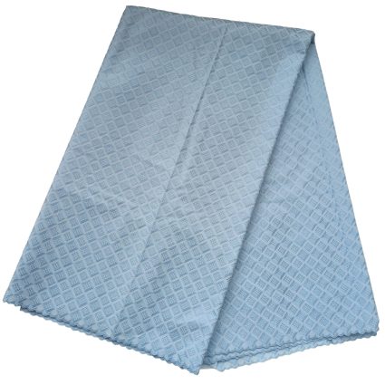 Light blue cloth napkin with a diamond pattern, folded diagonally.