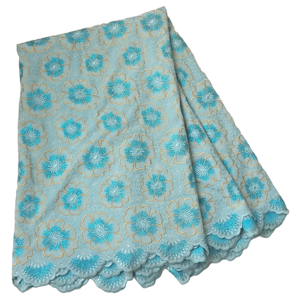 Premium Sky Blue Swiss Voile Lace Fabric with Turquoise and Gold Floral Embroidery Stone Accents 5 Yards - Imavug Light blue fabric with turquoise floral pattern and scalloped lace edge, folded neatly.