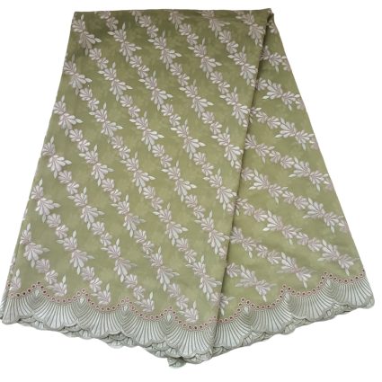 Light green fabric with diagonal white embroidered leaf pattern and scalloped lace border at the edge.