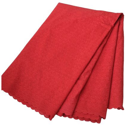 Red lace fabric folded with a scalloped edge, featuring a delicate floral eyelet pattern