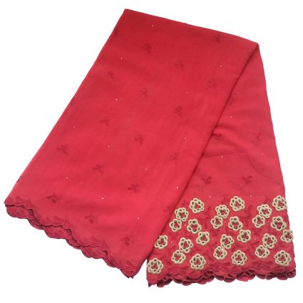 Red shawl with pale cream floral lace trim along the edge and small embroidered motifs throughout