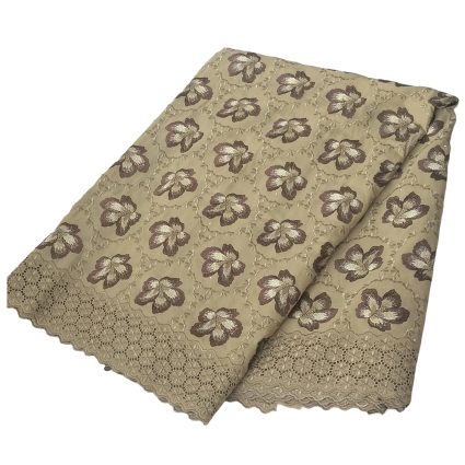 Beige fabric with brown floral pattern and scalloped lace trim, folded into layers.