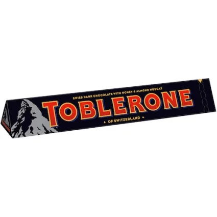 Slanted Toblerone chocolate bar wrapper with mountain logo and bold red letters TOBLERONE.