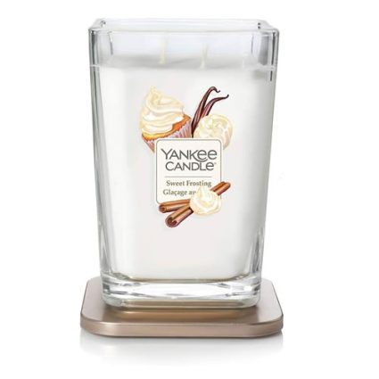 Yankee Candle Sweet Frosting in a square glass jar resting on a bronze base, with frosting and cinnamon graphics on the label.