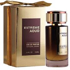 Perfume bottle with a gold cap beside a beige box labeled 'Extreme Aoud' (Eau de Parfum).