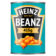 Can of Heinz Beanz (415 g) with turquoise label and orange beans spilling at the bottom on a blue background.