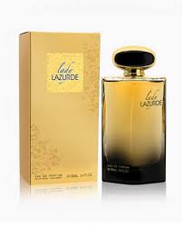 Perfume bottle with a gradient amber liquid beside a gold box.