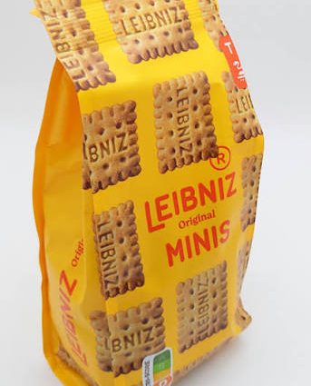 Bright yellow Leibniz Minis biscuit bag standing upright against a white background, showing cookie images and the 'LEIBNIZ original MINIS' label.
