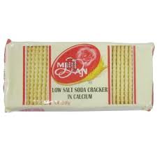 Package of low-salt calcium-enriched soda crackers, rectangular wrapper with a red circular logo and yellow stripes.