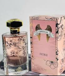 Perfume bottle with pale pink liquid next to a pink floral box labeled 'OPHYLLA FIORE'