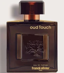 Fragrance bottle labeled Oud Touch by Franck Olivier, dark rectangular glass with bronze cap and gold lettering.
