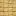 Close-up of sesame-covered brittle squares arranged in a grid on a light surface.