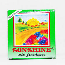 Sunshine air freshener box with a colorful landscape artwork on a green package, branding visible.